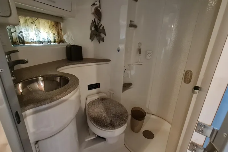 Slide: The Image of 1998 Formula 41 Performance Cruiser bathroom with sink, toilet, and shower. - 25