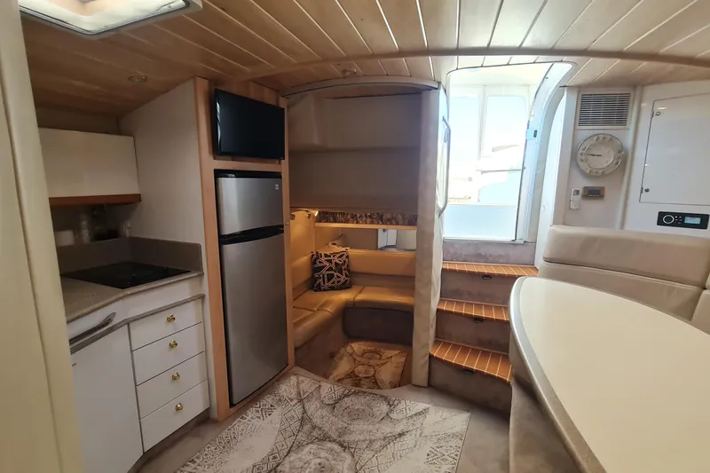 Slide: The Image of 1998 Formula 41 Performance Cruiser interior with kitchen, seating, and stairs. - 29