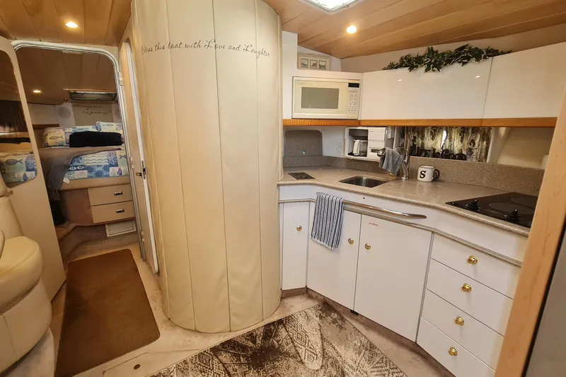Slide: The Image of 1998 Formula 41 Performance Cruiser interior with kitchen and cozy bedroom. - 33