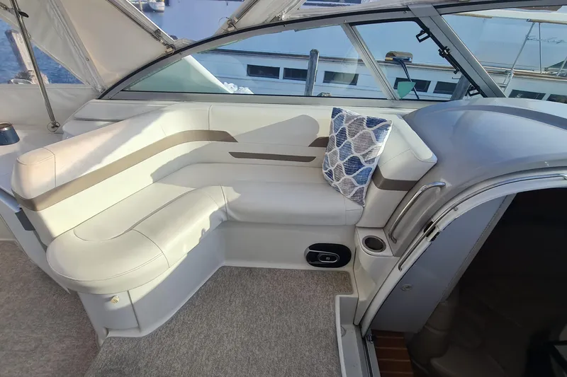 Slide: The Image of Interior of a 1998 Formula 41 Performance Cruiser with white seating and decorative pillow. - 6