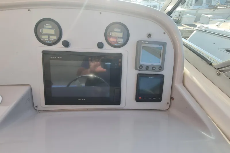 Slide: The Image of 1998 Formula 41 Performance Cruiser dashboard with Garmin GPS and control gauges. - 8