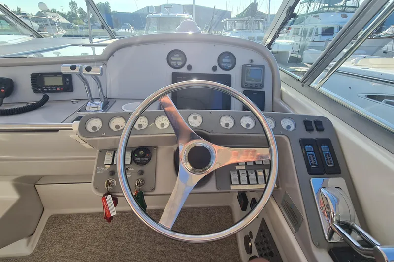 Slide: The Image of Steering wheel and dashboard of a 1998 Formula 41 Performance Cruiser boat. - 9