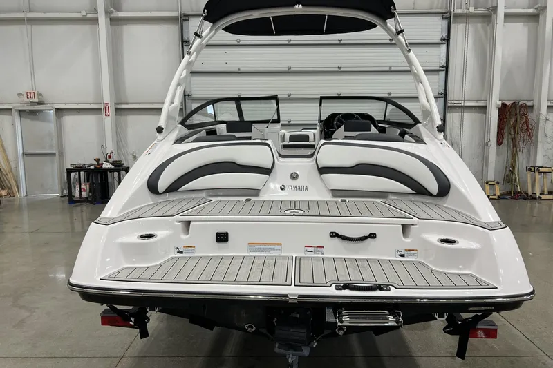 Slide: The Image of 2025 Yamaha Boats 195S in a showroom, showcasing sleek design and spacious seating. - 3
