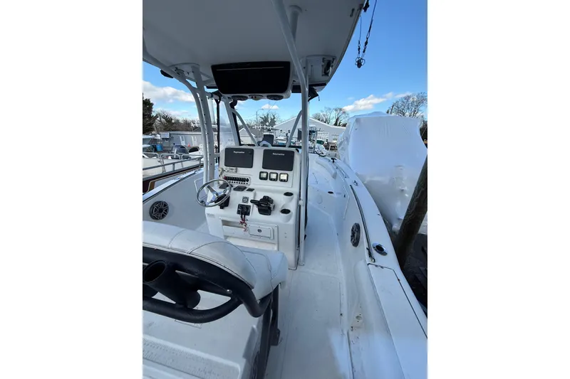 Slide: The Image of 2012 Tidewater 250 CC Adventure boat cockpit with steering and navigation controls. - 10