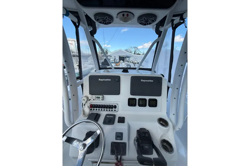 Slide: The Image of 2012 Tidewater 250 CC Adventure boat console with Raymarine electronics and steering wheel. - 12