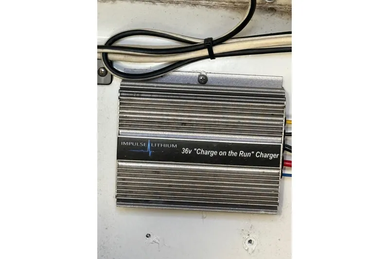 Slide: The Image of Impulse Lithium 36V "Charge on the Run" charger in Tidewater 250 CC Adventure boat. - 21