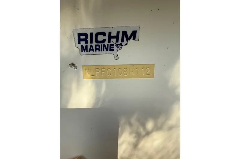 Slide: The Image of 2012 Tidewater 250 CC Adventure boat with Rich Marine sticker and serial number visible. - 27