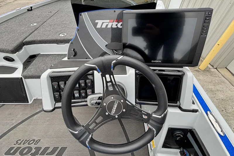 Slide: The Image of Steering console of 2026 Triton 20XP Patriot boat with Garmin display and controls. - 11