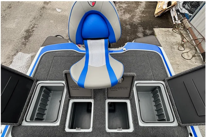 Slide: The Image of Triton 20XP Patriot 2026 boat interior with storage compartments and blue-gray seat. - 16