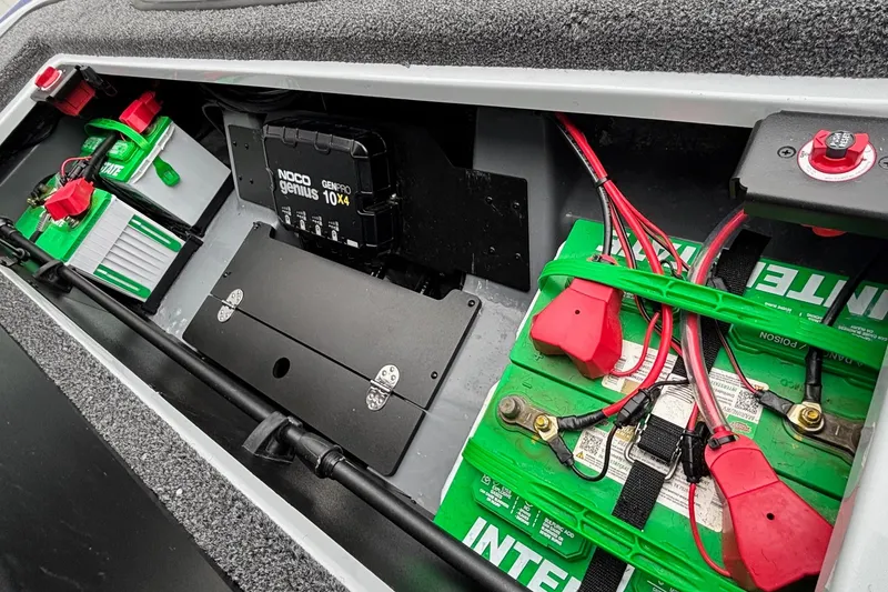Slide: The Image of Battery compartment of 2026 Triton 20XP Patriot with NOCO Genius charger and Interstate batteries. - 17