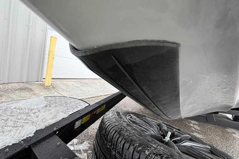 Slide: The Image of 2026 Triton 20XP Patriot boat hull on trailer, close-up view. - 2