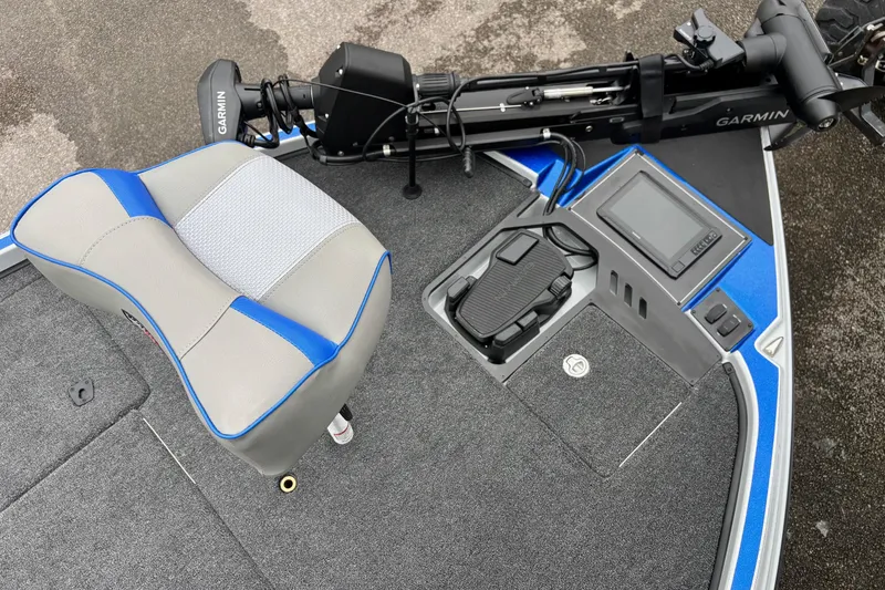 Slide: The Image of 2026 Triton 20XP Patriot boat interior with Garmin equipment and blue-accented seating. - 5