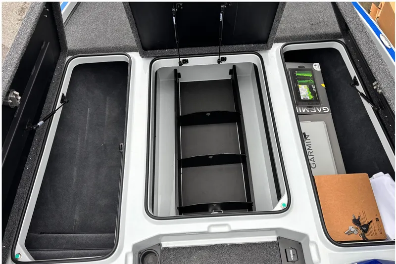 Slide: The Image of Triton 20XP Patriot 2026 boat storage compartments with Garmin equipment. - 7