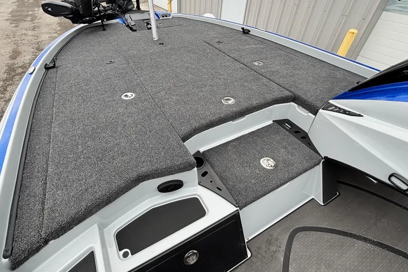 Slide: The Image of 2026 Triton 20XP Patriot boat deck with gray carpet and storage compartments. - 8