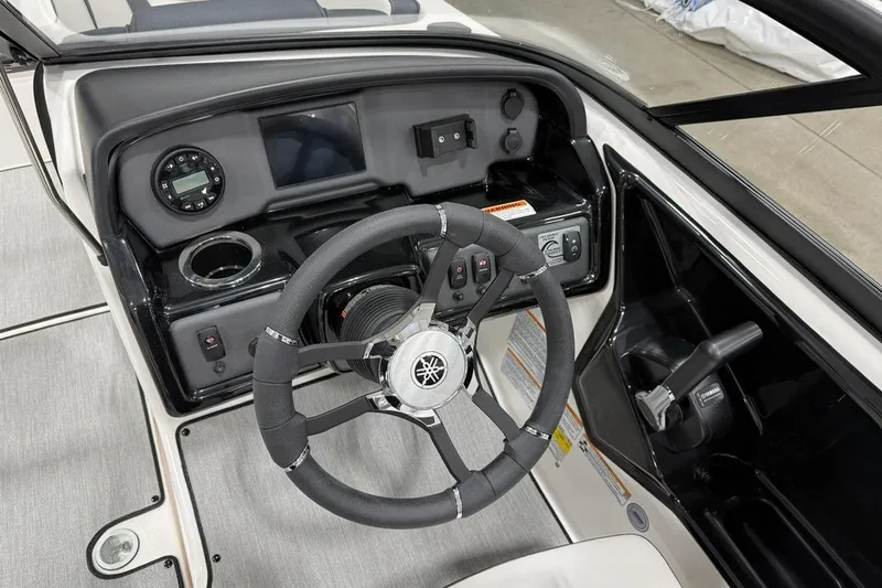Slide: The Image of 2025 Yamaha Boats SX195 dashboard with steering wheel and controls, featuring modern design elements. - 5