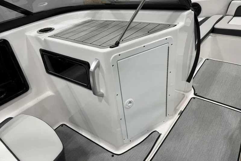 Slide: The Image of 2025 Yamaha Boats SX195 interior with storage compartment and seating area. - 9