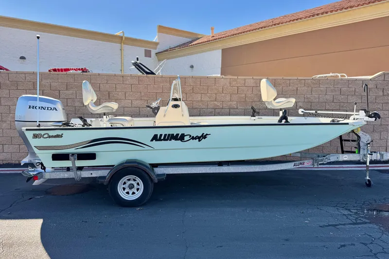 The Image of 2020 Alumacraft 2072 Bay boat on trailer, featuring Honda outboard motor. - 0