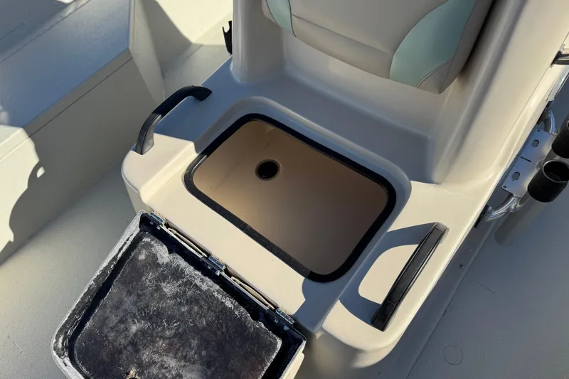 Slide: The Image of 2020 Alumacraft 2072 Bay boat storage compartment with open lid, showcasing interior space. - 19