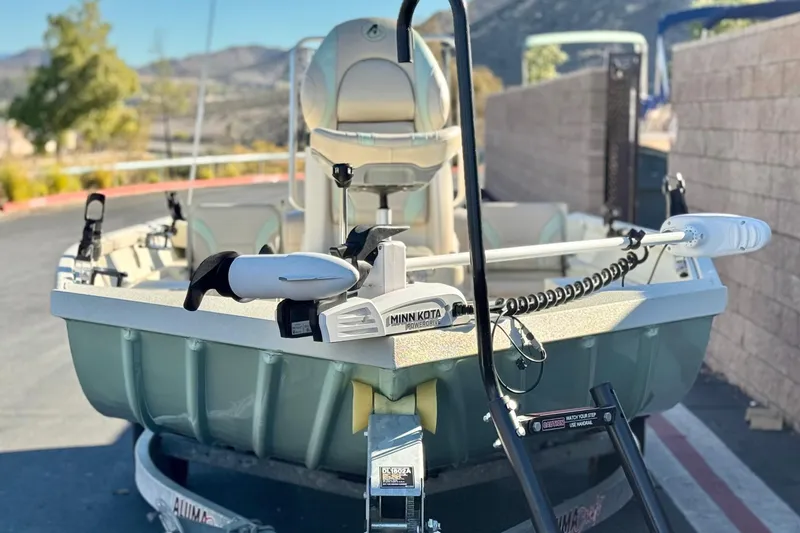 Slide: The Image of 2020 Alumacraft 2072 Bay boat with Minn Kota trolling motor, parked outdoors. - 2