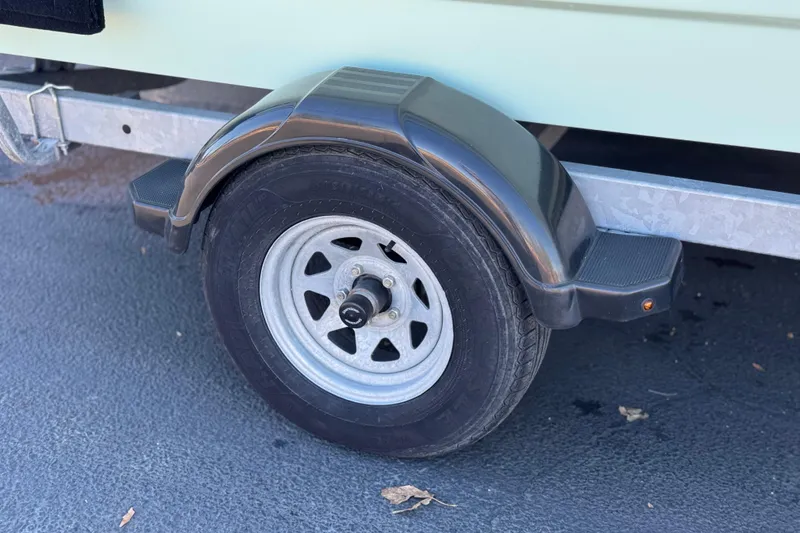 Slide: The Image of Trailer wheel of 2020 Alumacraft 2072 Bay boat on pavement. - 28