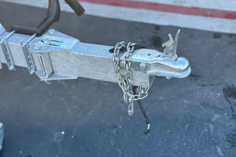 Slide: The Image of Trailer hitch of a 2020 Alumacraft 2072 Bay boat with safety chains attached. - 29