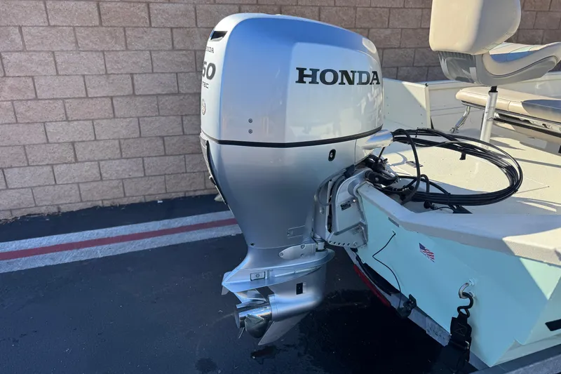 Slide: The Image of 2020 Alumacraft 2072 Bay boat with Honda outboard motor, parked on pavement. - 6