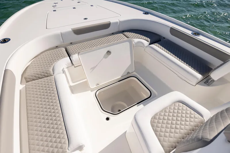 Slide: The Image of 2026 Caymas 26 HB boat interior with cushioned seating and storage compartment. - 12