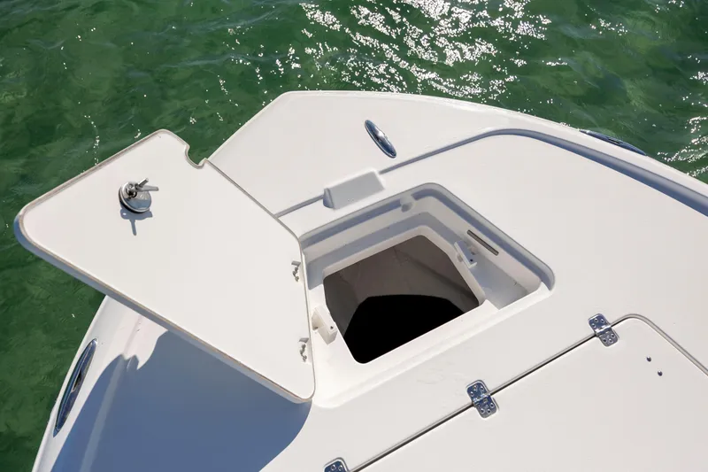 Slide: The Image of Open storage compartment on 2026 Caymas 26 HB boat, floating on clear water. - 15