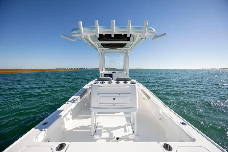 Slide: The Image of 2026 Caymas 26 HB boat on open water under clear blue sky. - 20