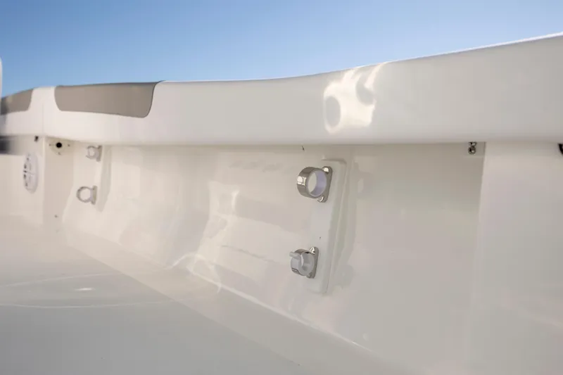 Slide: The Image of 2026 Caymas 26 HB boat interior detail with sleek white finish and metal fixtures. - 21