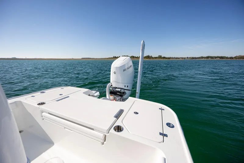 Slide: The Image of 2026 Caymas 26 HB boat on open water with Mercury engine. - 23