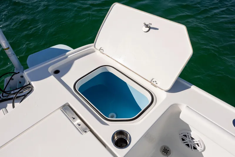 Slide: The Image of 2026 Caymas 26 HB boat with open storage compartment on deck. - 26