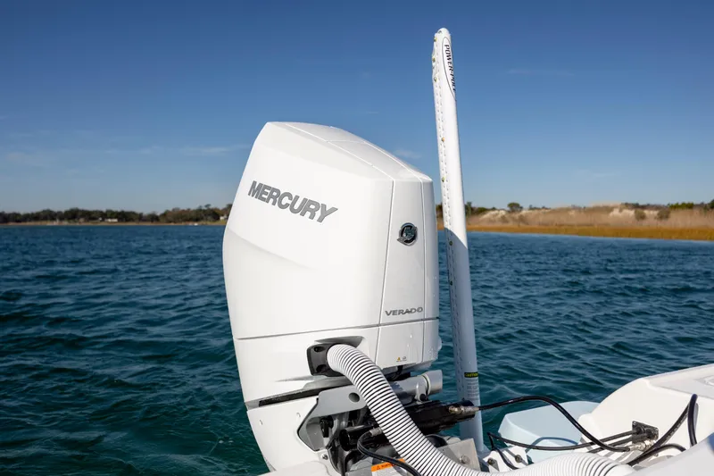 Slide: The Image of 2026 Caymas 26 HB with Mercury Verado engine on open water. - 27