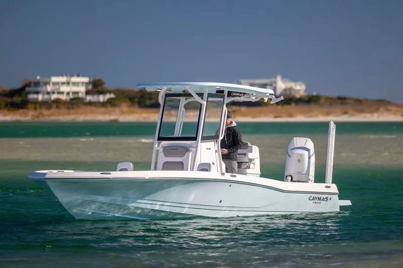 Slide: The Image of 2026 Caymas 26 HB boat cruising on clear waters near a coastal area. - 6