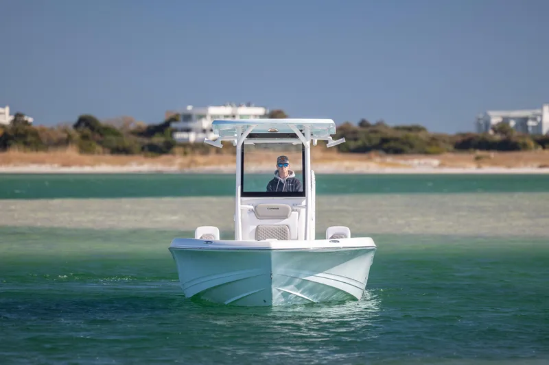 Slide: The Image of 2026 Caymas 26 HB boat cruising on clear waters near a scenic shoreline. - 7