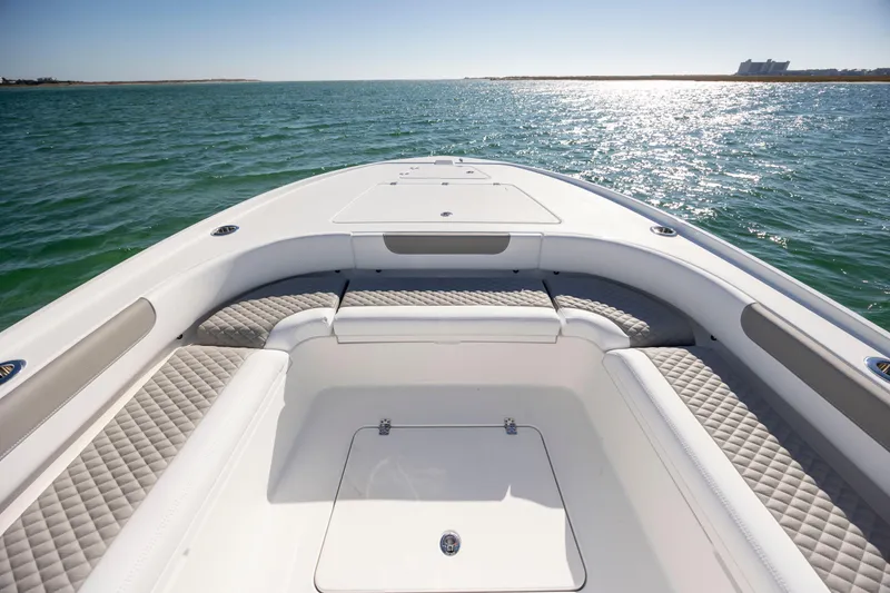 Slide: The Image of 2026 Caymas 26 HB boat on open water, featuring spacious seating and sleek design. - 9
