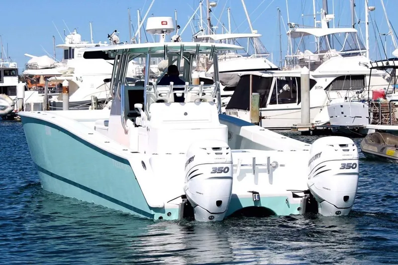 Slide: The Image of 2013 Freeman 33 boat "Lady K" displayed for sale, with signs for used and new boats. - 1