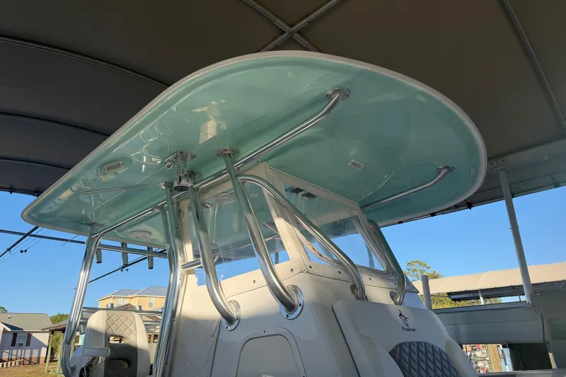 Slide: The Image of 2013 Freeman 33 boat interior with steering console and rod holders. - 11