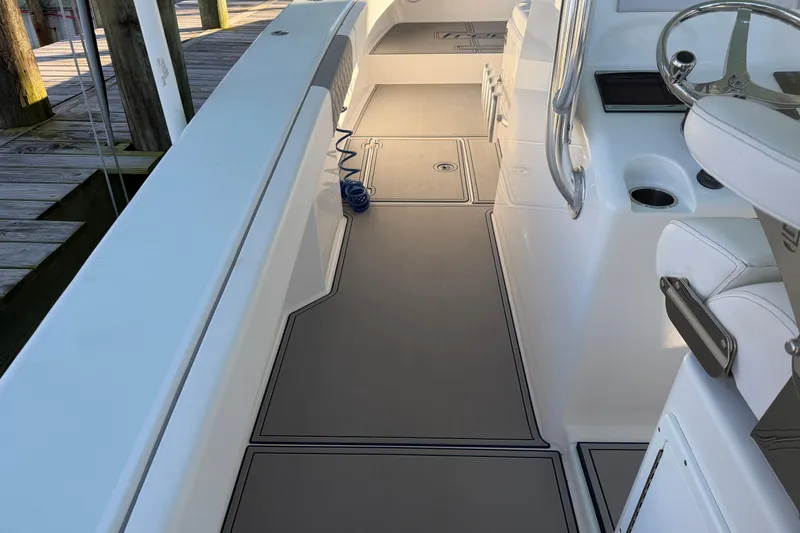 Slide: The Image of Freeman 33 boat with twin Mercury outboard engines, docked on calm water, 2013 model. - 16