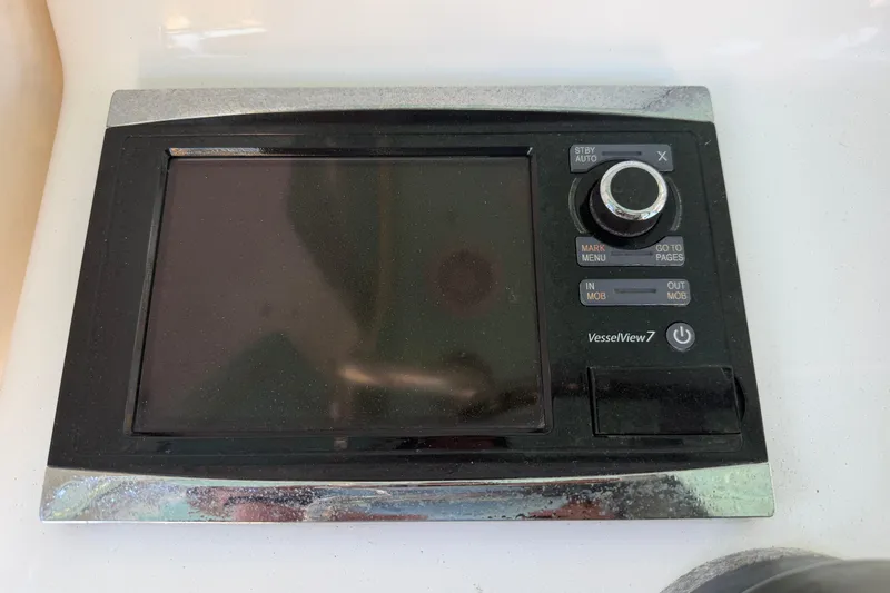 Slide: The Image of Freeman 33 boat dashboard with Simrad electronics, steering wheel, and control panel, 2013 model. - 23