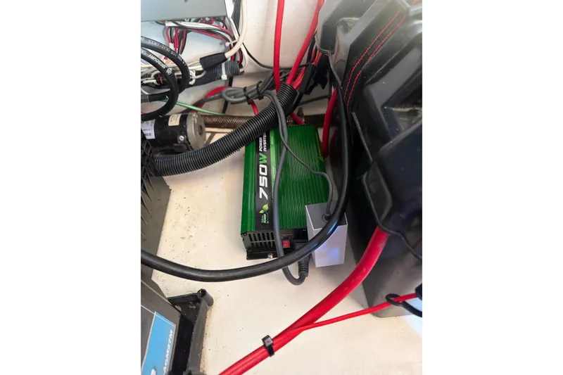 Slide: The Image of Electrical setup and storage area inside a 2013 Freeman 33 boat. - 28
