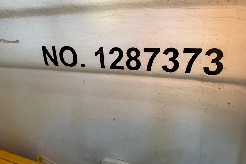 Slide: The Image of Red marine batteries and wiring in a 2013 Freeman 33 boat engine compartment. - 36