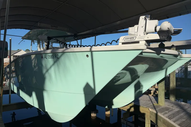 Slide: The Image of Twin Mercury outboard engines on a 2013 Freeman 33 boat docked by the water. - 4