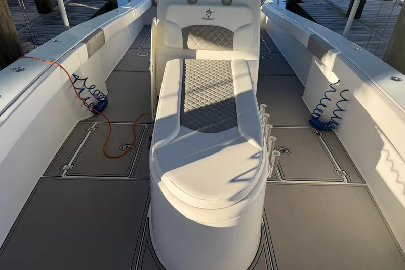 Slide: The Image of Open storage compartment on a 2013 Freeman 33 boat, containing a red life jacket. - 42