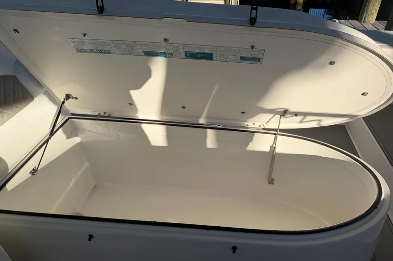 Slide: The Image of Storage compartment with red life jacket, ropes, and anchor on a 2013 Freeman 33 boat. - 43