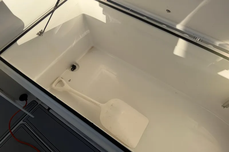 Slide: The Image of Open storage compartment on Freeman 33 boat with red life jackets inside, 2013 model. - 44