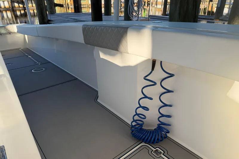 Slide: The Image of Open storage compartment in 2013 Freeman 33 boat with a white shovel inside. - 47