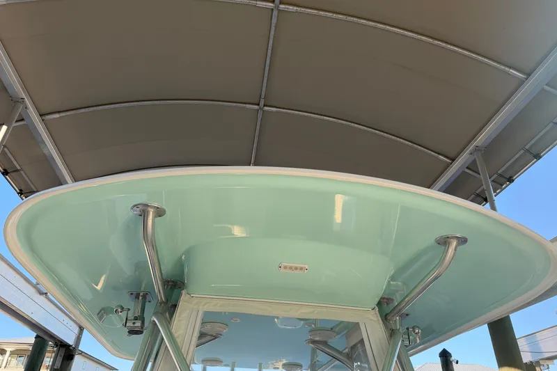 Slide: The Image of Interior of a 2013 Freeman 33 boat with coiled blue hose and cushioned seating. - 49