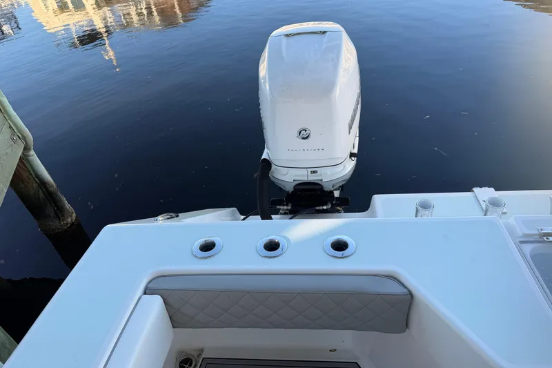 Slide: The Image of 2013 Freeman 33 boat with outboard motor on calm water. - 79