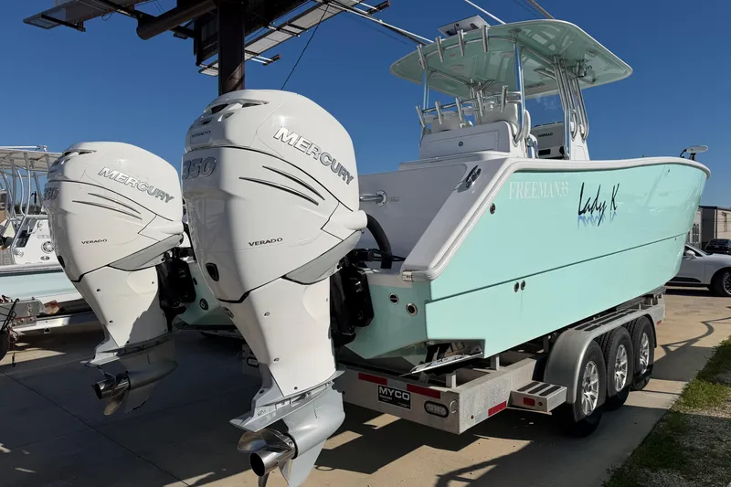 Slide: The Image of 2013 Freeman 33 boat with twin Mercury Verado engines on a trailer. - 80